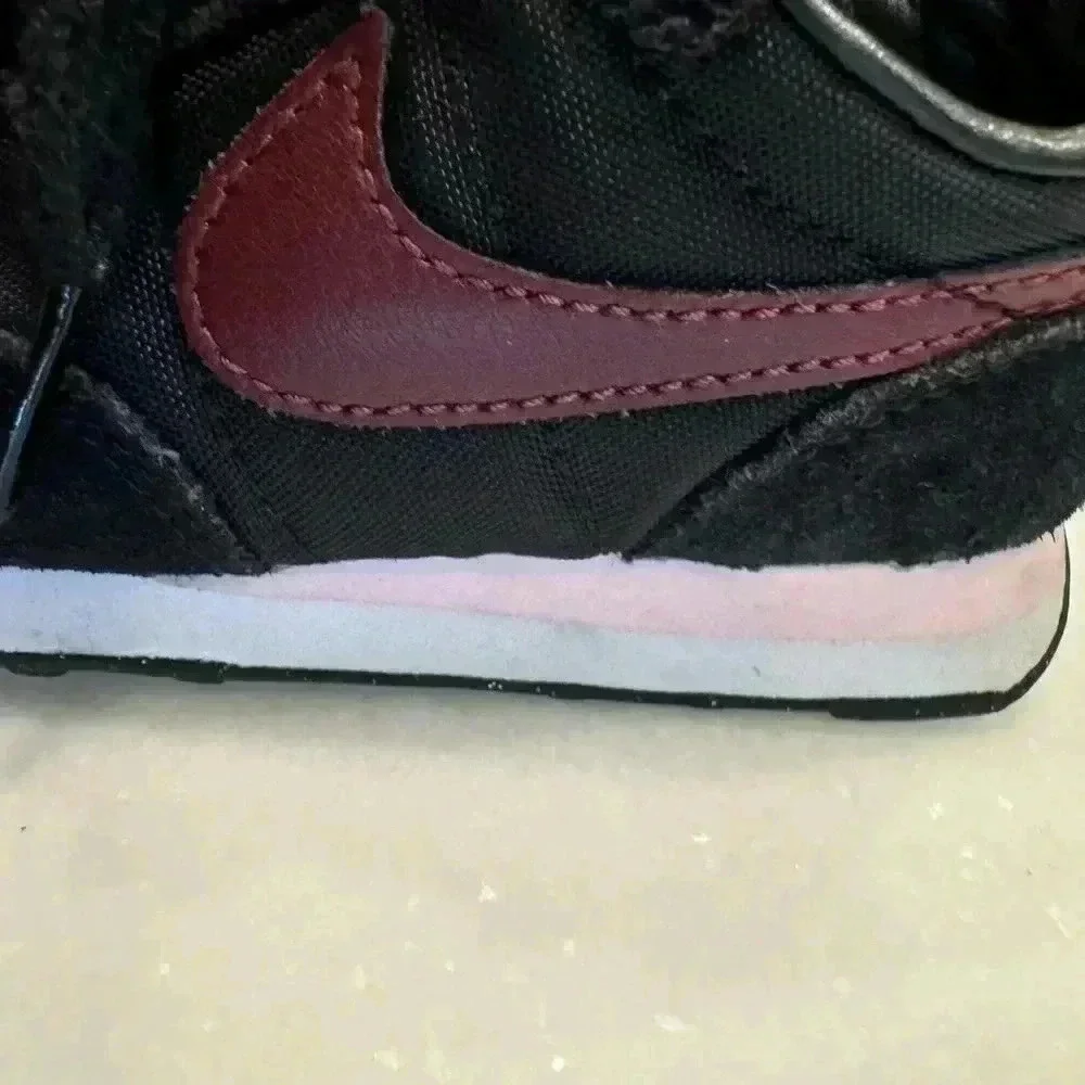 Nike baby girl suede sneakers size 6c. Black with burgandy nike logo.